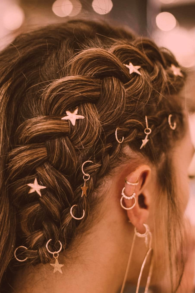 Braided pigtails with hair rings edgy festival hairstyle trend