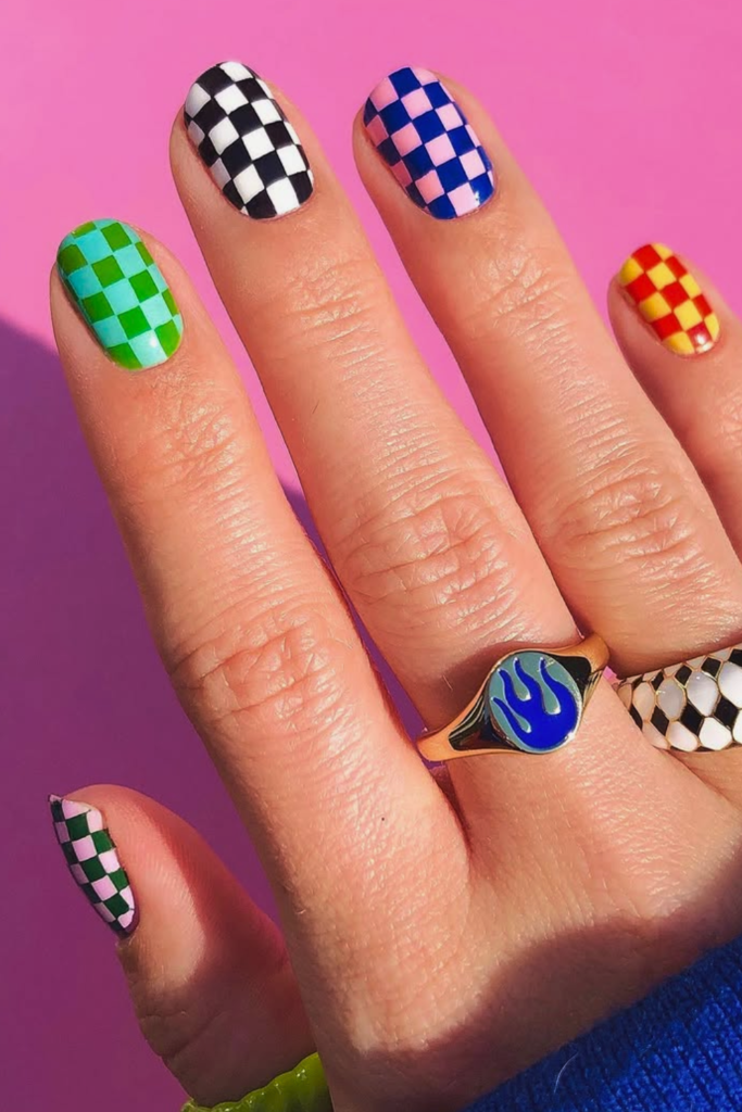 Checkerboard funky nails with bold color contrast and graphic nail design style