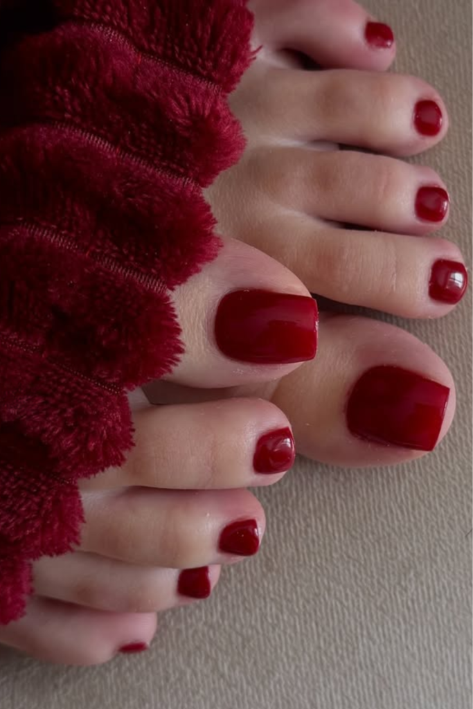 cherry red toe nails with glossy finish, classic summer pedicure color idea for bold and elegant nails