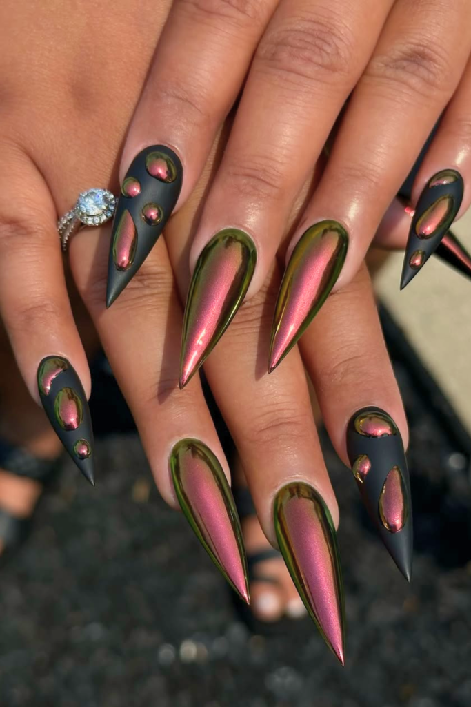 Edgy black chrome festival nails with dark reflective finish for bold nail design
