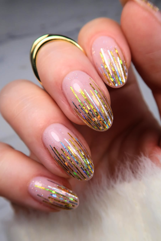 Gold flake festival nails with subtle metallic pieces and elegant nail design
