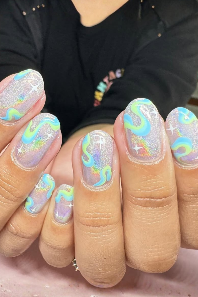 Holographic mirror festival nails with reflective chrome finish and futuristic nail art style