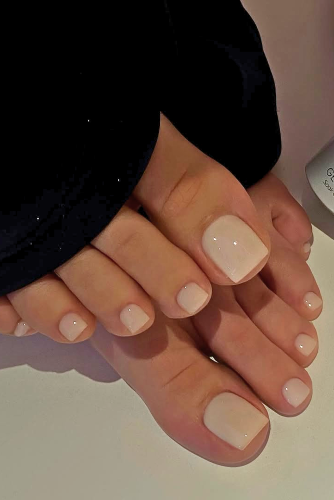 milky white toe nails with glossy finish, minimalist clean girl summer pedicure design for elegant look