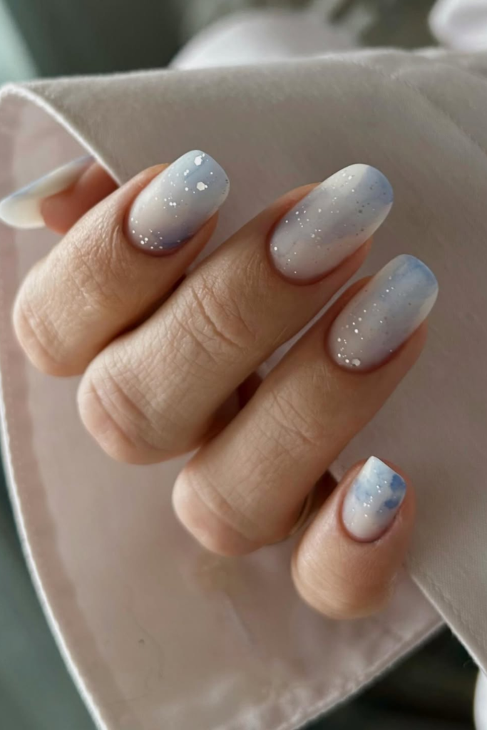 milky white nails with deep blue tips ocean inspired manicure