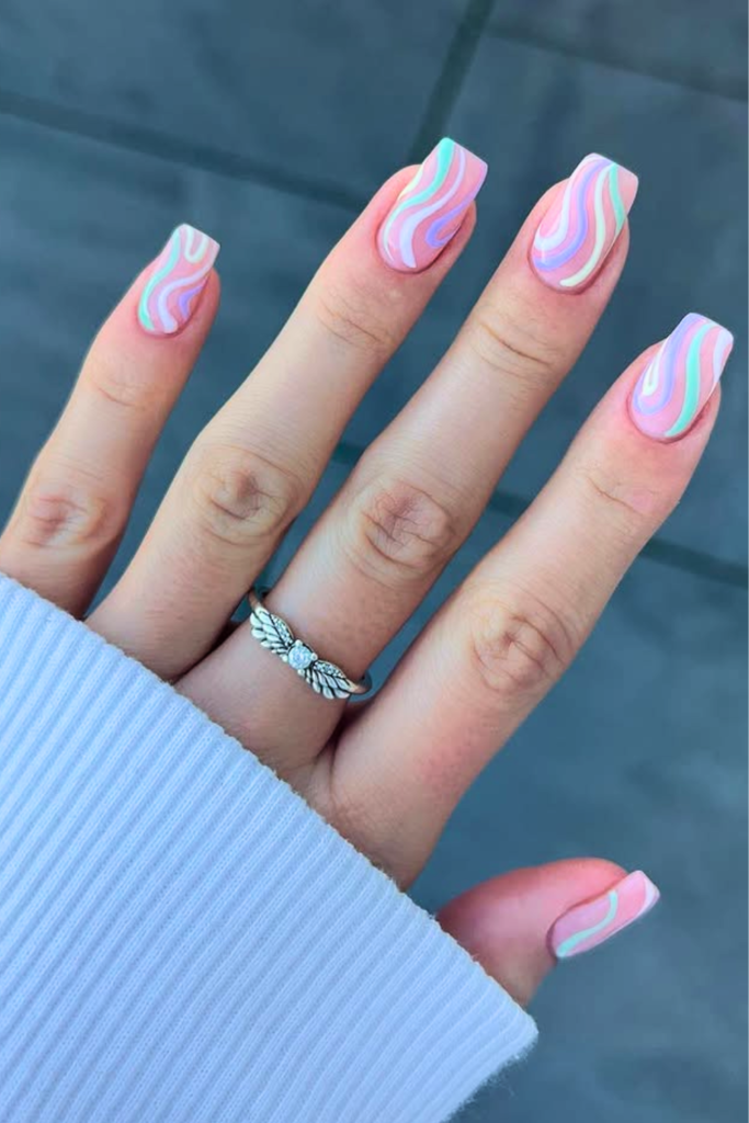 pastel swirl summer birthday nails with soft colors and abstract glossy nail design