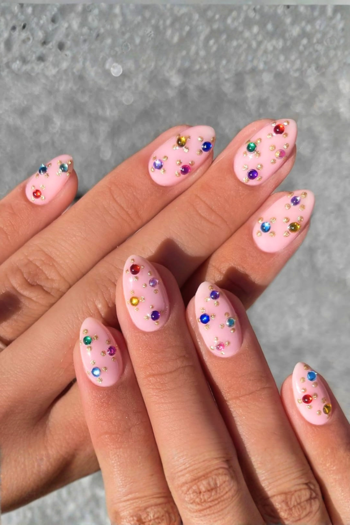 Rhinestone gemstone festival nails with sparkling crystal accents and glamorous nail art design