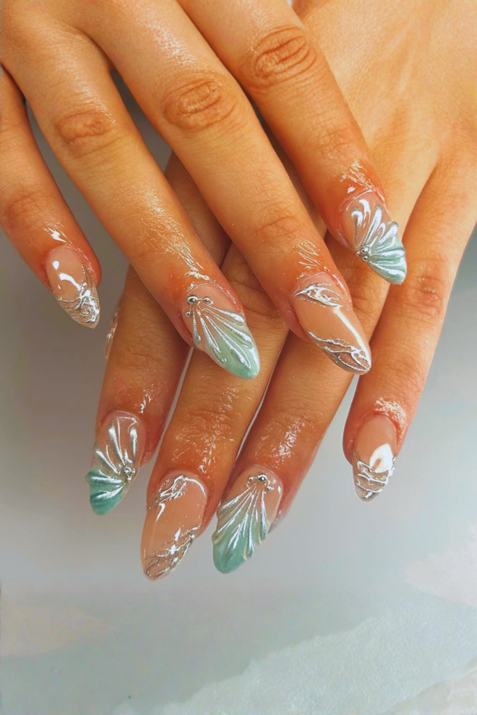 shell inspired nail art with soft blue tones summer nails