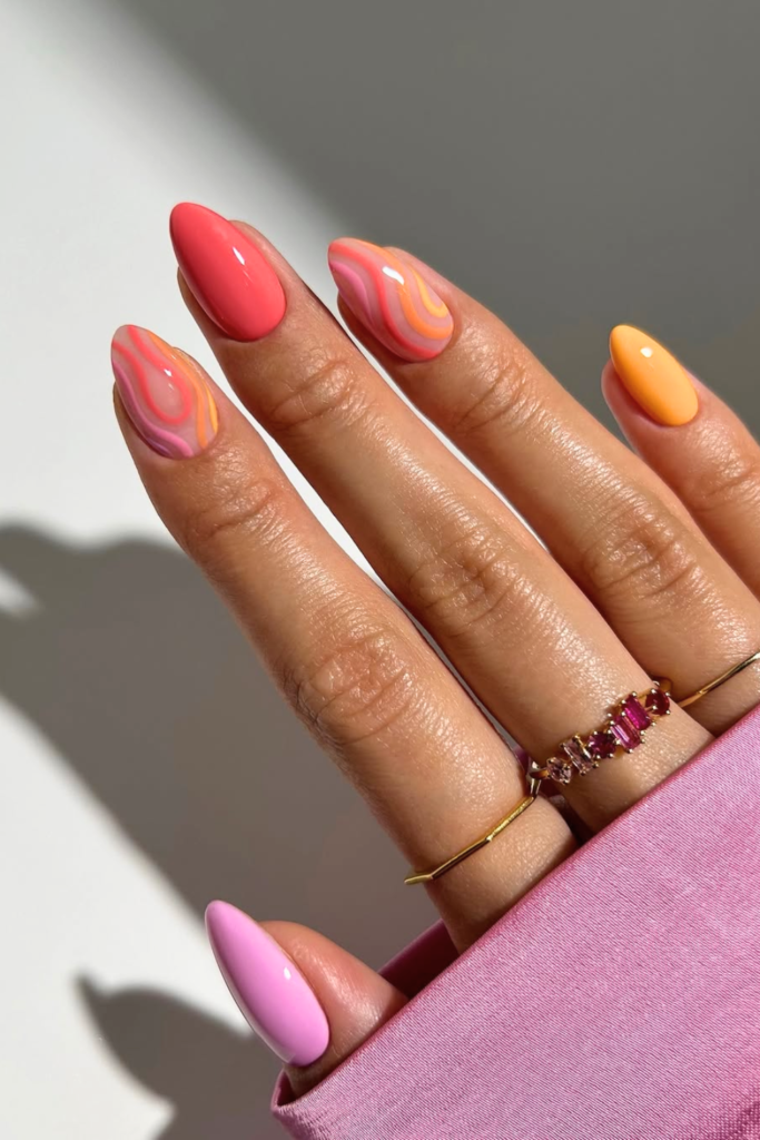 Sunset gradient summer festival nails with warm orange and pink tones inspired by sunset