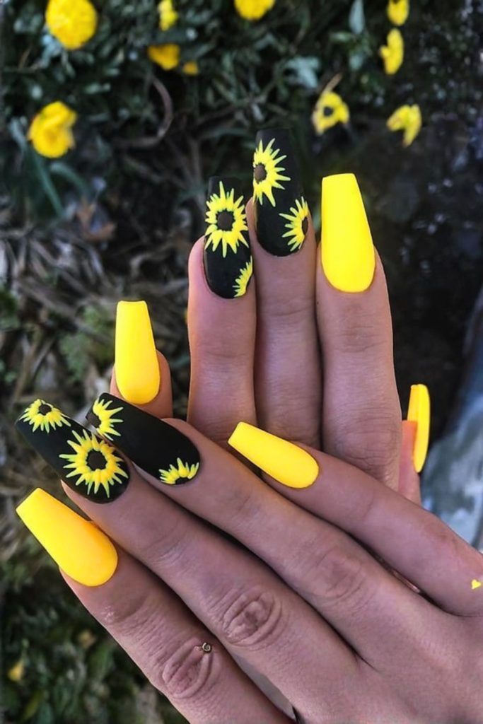 black nails with bright sunflower art high contrast floral design