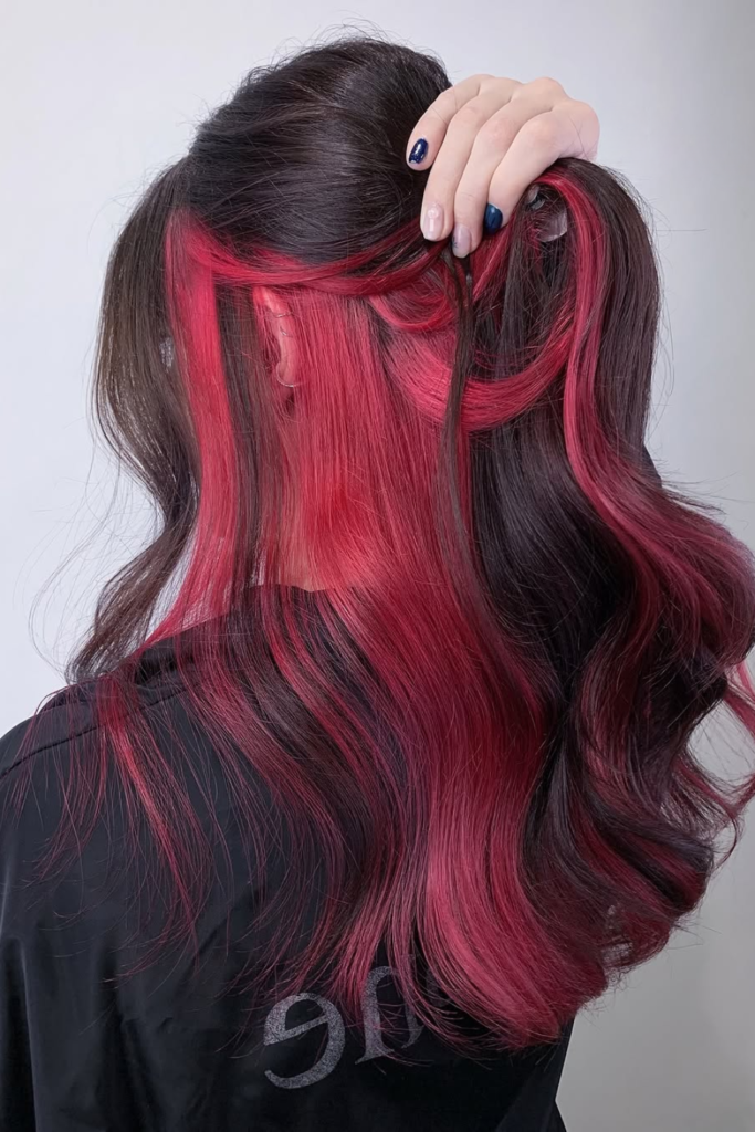 Burgundy peekaboo highlights on black hair
