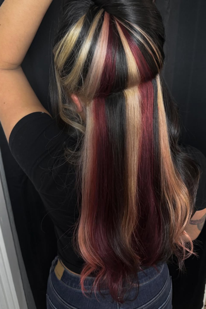 Chunky Y2K peekaboo highlights on brunette hair