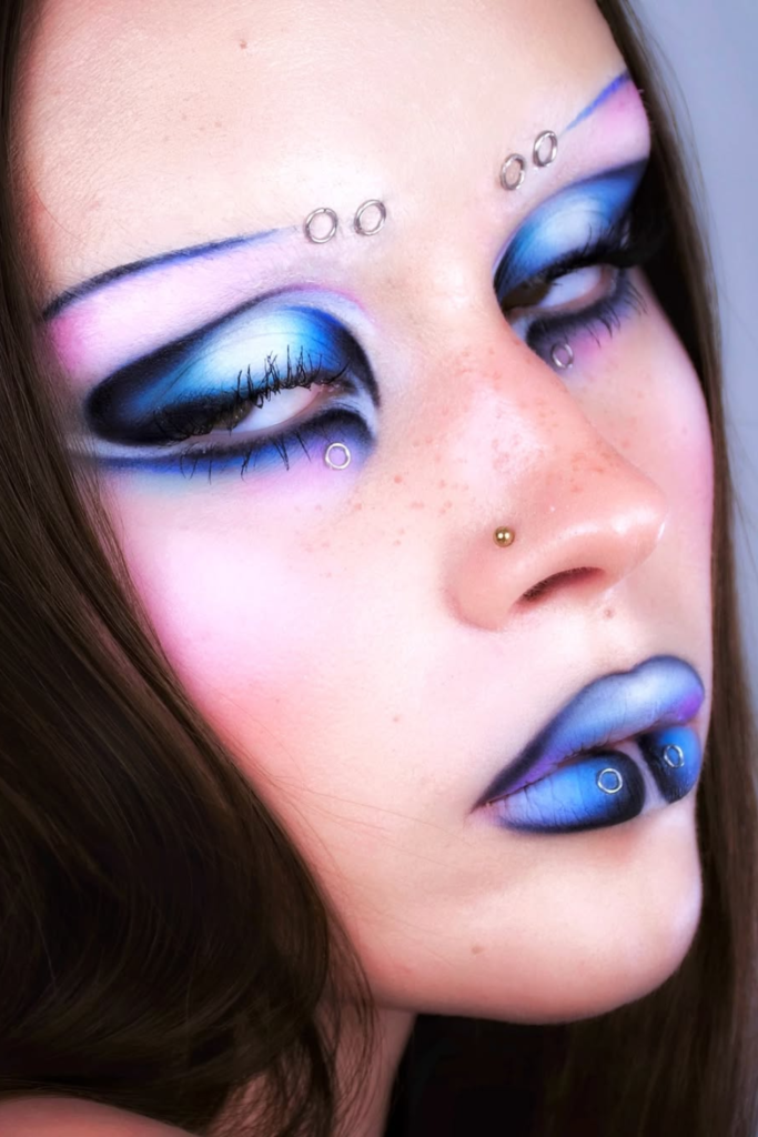 Dark feminine makeup with burgundy shimmer and glossy eyes