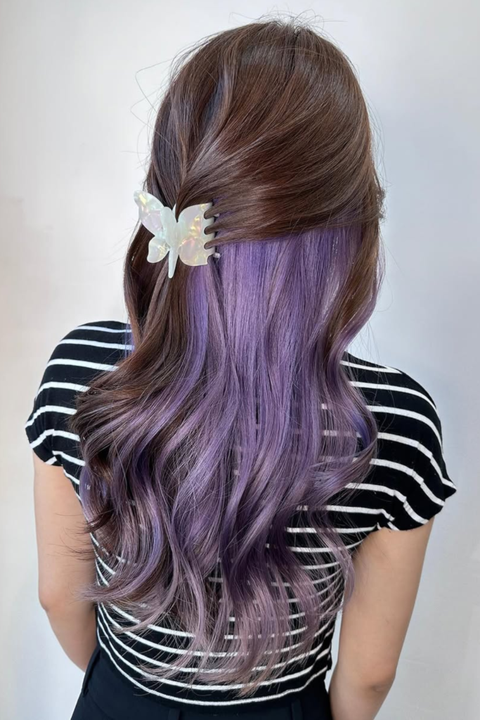 Lavender peekaboo highlights on layered hair