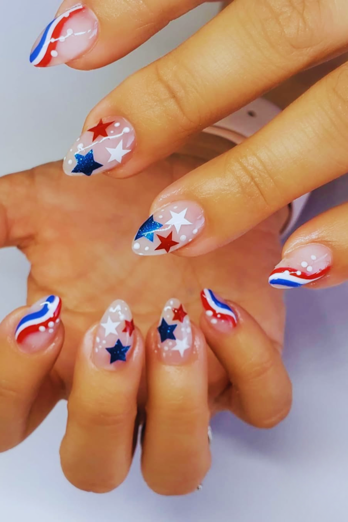 Micro star almond nails with glossy nude patriotic manicure