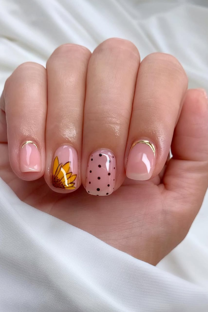 short nude nails with tiny sunflower accents clean minimal look