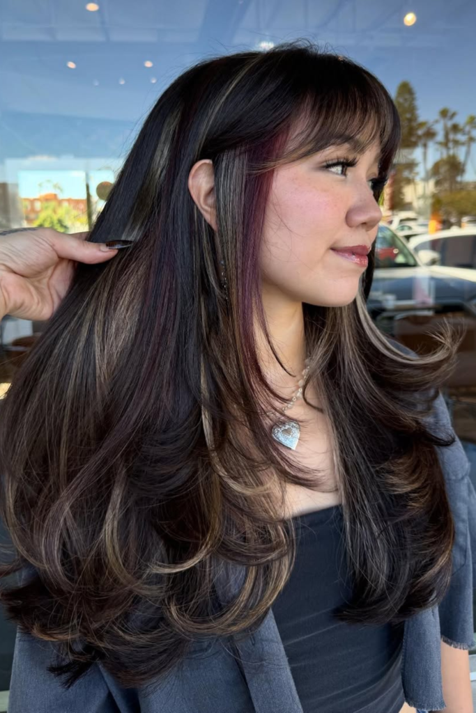 Subtle brunette underlights on layered hair