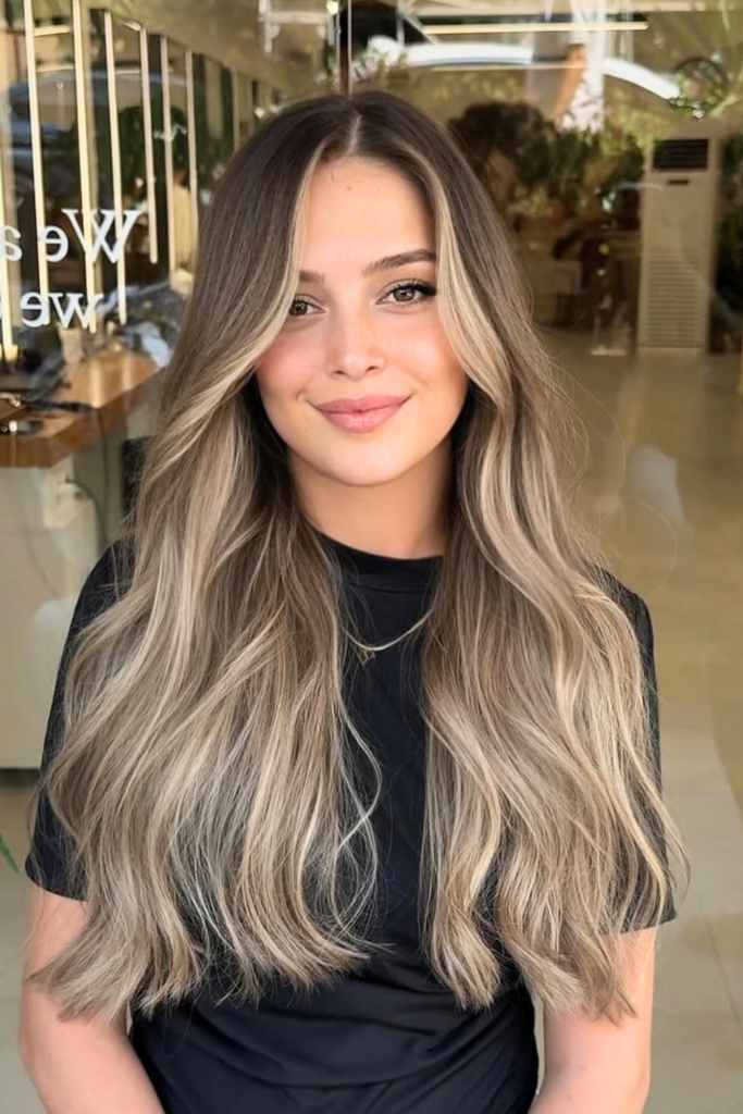 Warm sandy blonde ombre hair with soft beachy texture