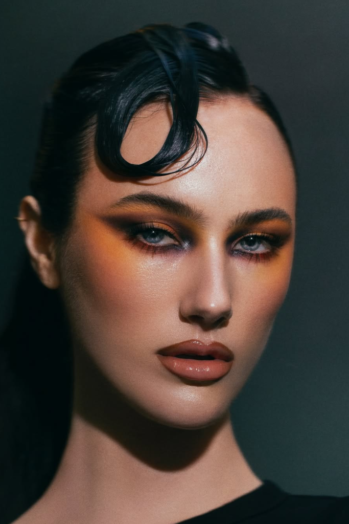 Tropical makeup look with coral eyeshadow and golden glow