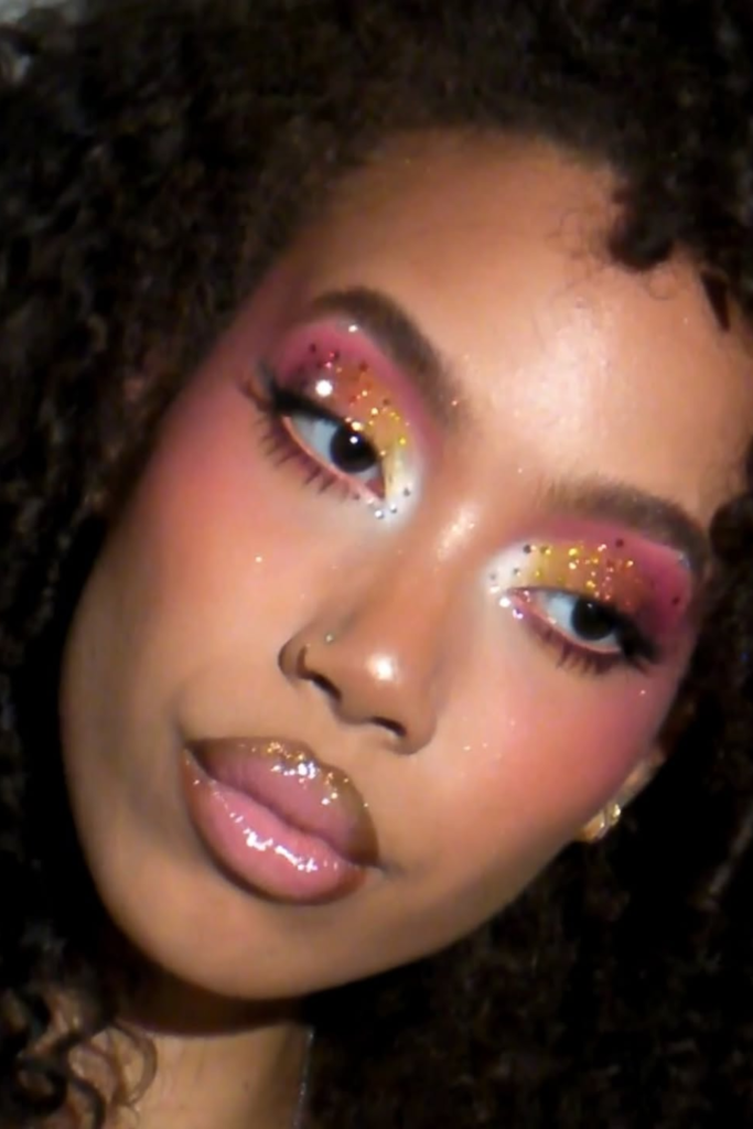 Festival makeup look with shimmer accents and bold lashes