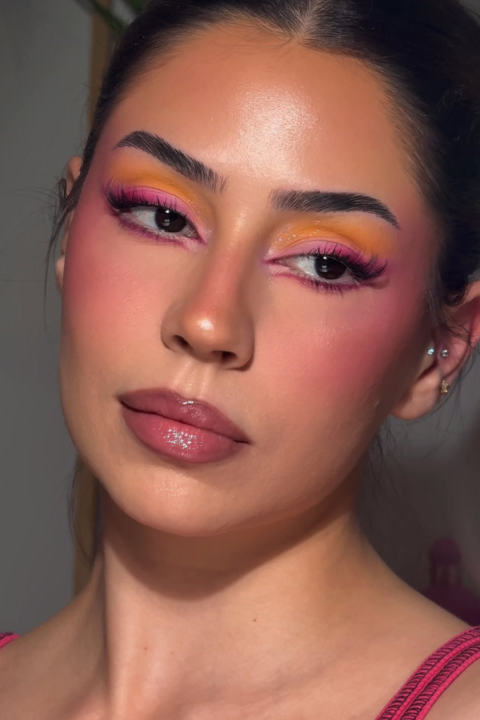 Sunset-inspired makeup with peach blush and golden glow