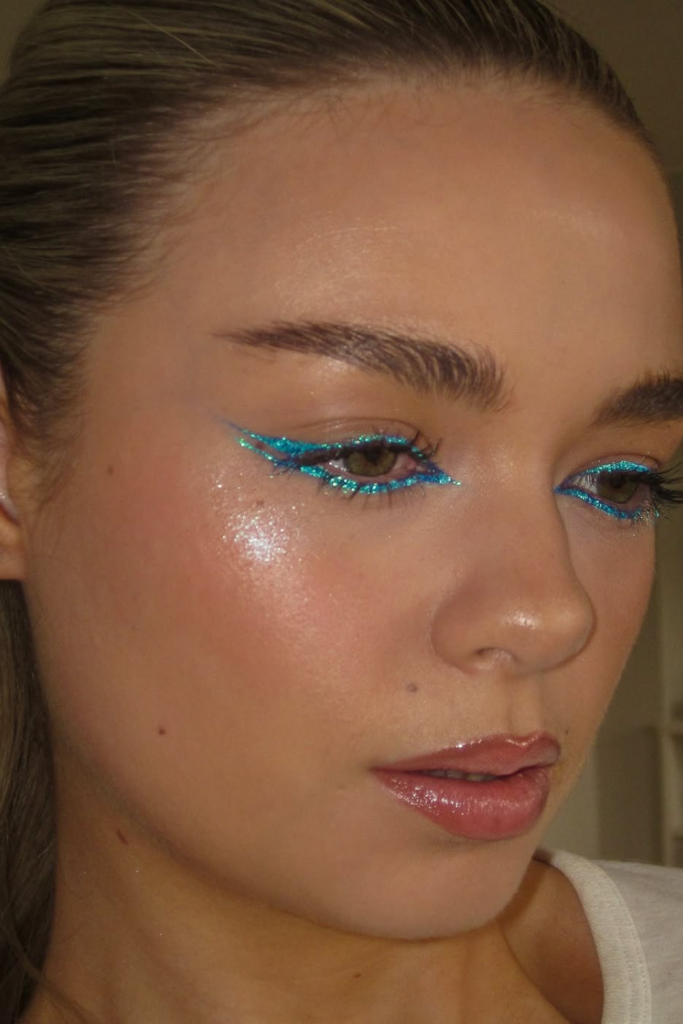 Beach club glam with bronzed cheeks and glossy lips