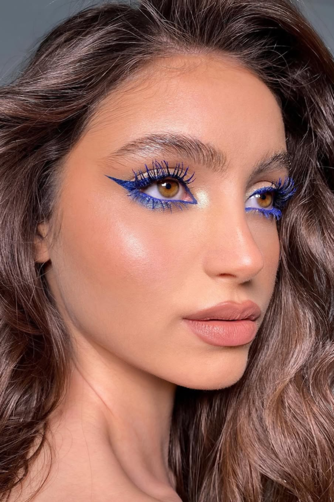Dewy skin and navy winged liner makeup look