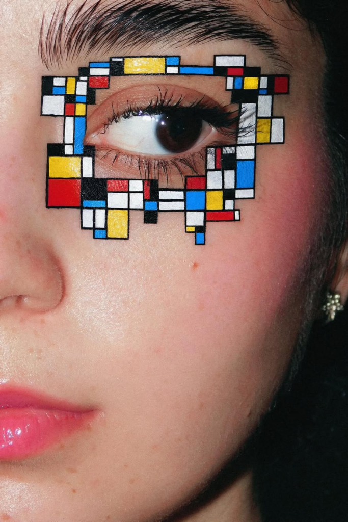 Geometric eyeliner design featuring bold angular shapes and artistic eye makeup