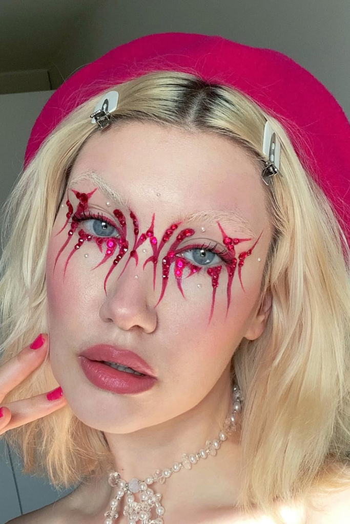 Creative eyeliner look with rhinestone accents and sparkling eye details
