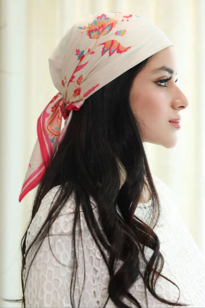 Low knot hairstyle with a silk scarf accent