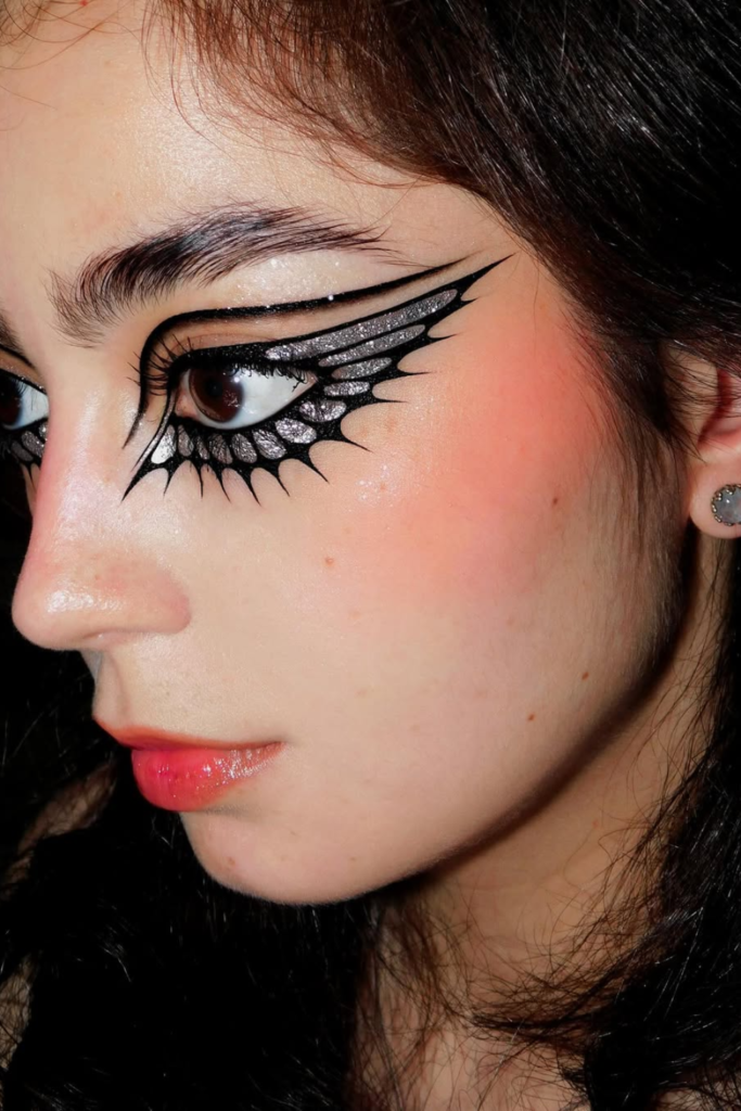Silver metallic eyeliner look with futuristic editorial eye makeup styling