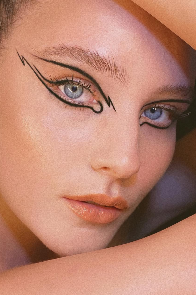 Split-wing eyeliner with negative space and contemporary eye makeup styling