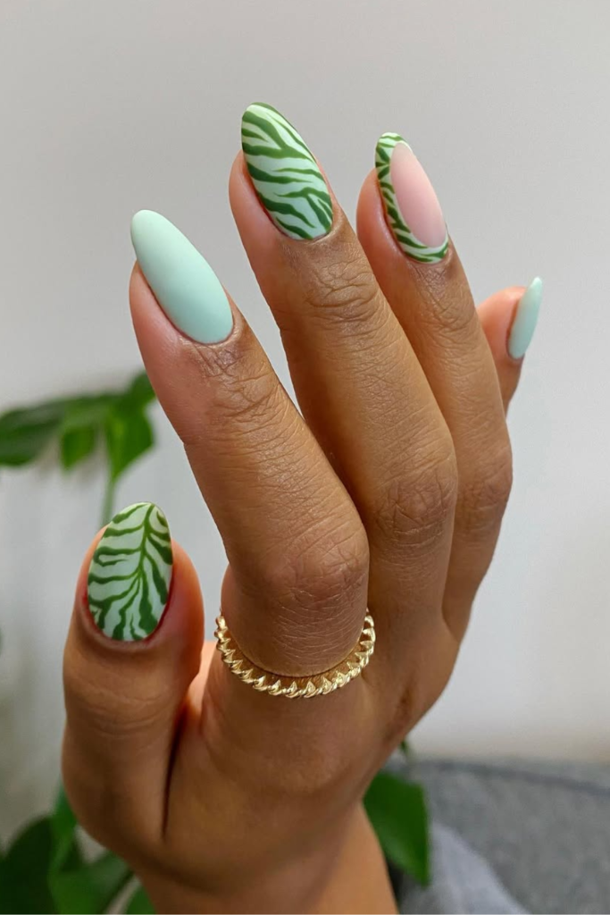 Sage green manicure with modern zebra stripe nail art