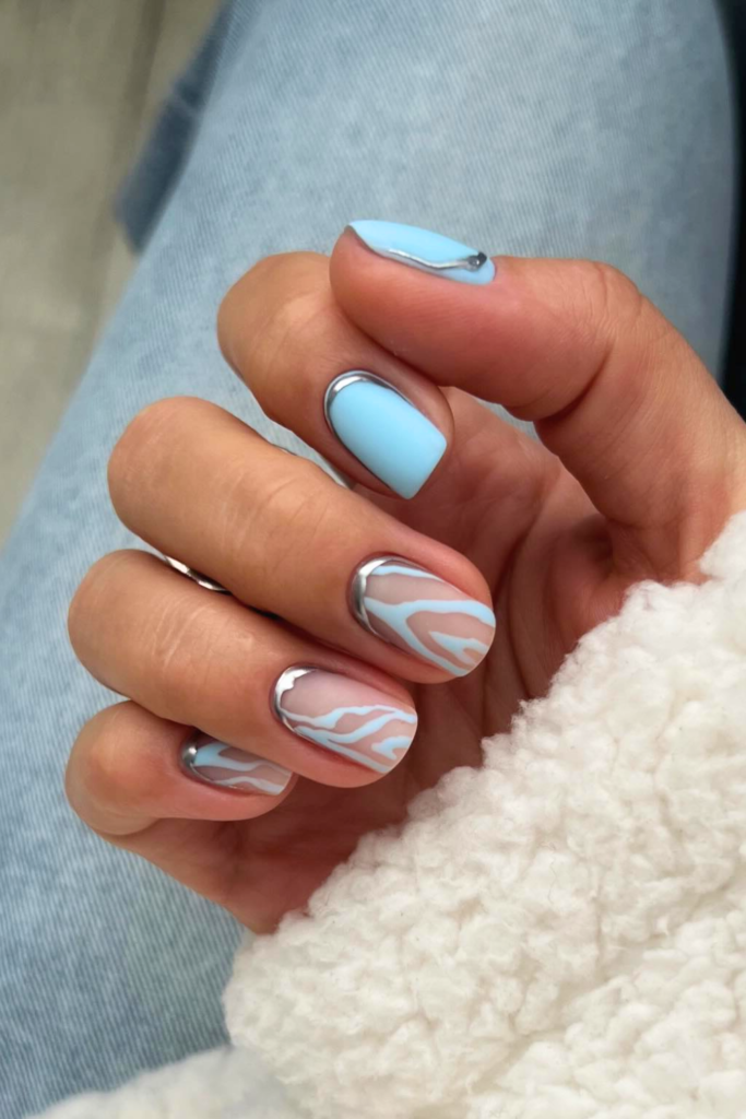 Ice blue animal print manicure with glossy finish