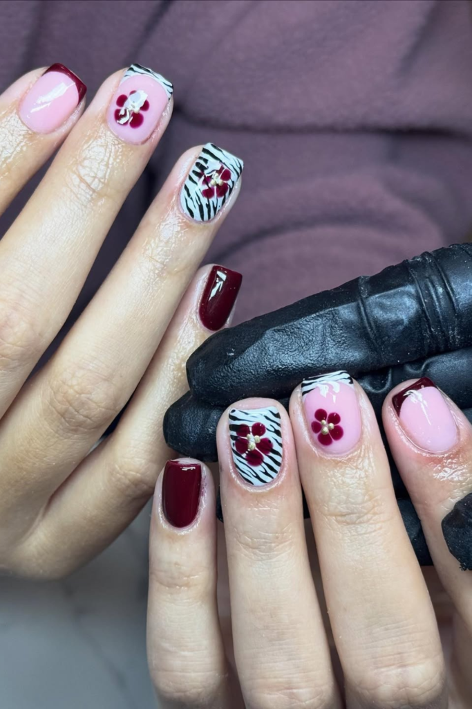 Burgundy manicure with bold zebra-inspired nail design