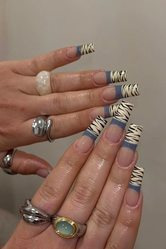 Negative space manicure with fine zebra line artwork