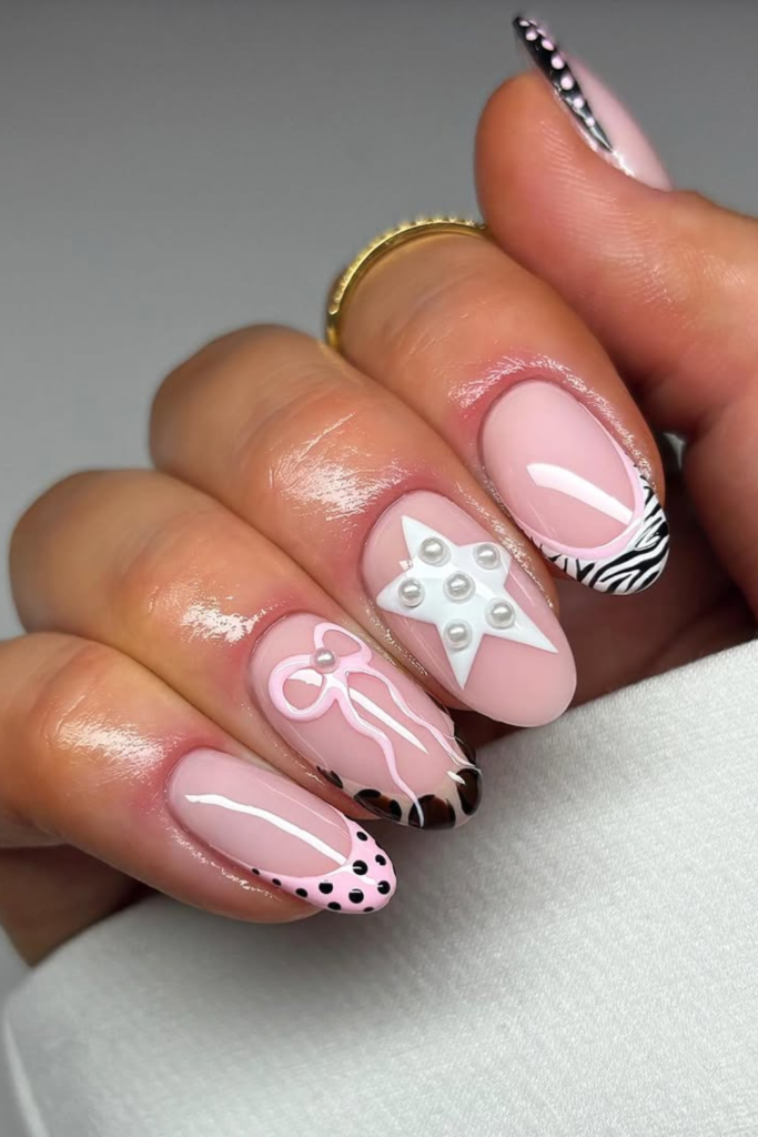 Coquette-inspired manicure with zebra stripes and tiny bow accents