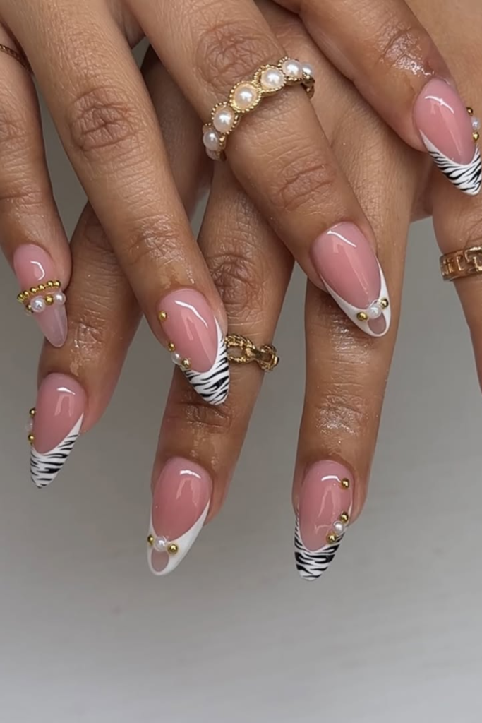 Pearl embellished animal print manicure with glossy finish